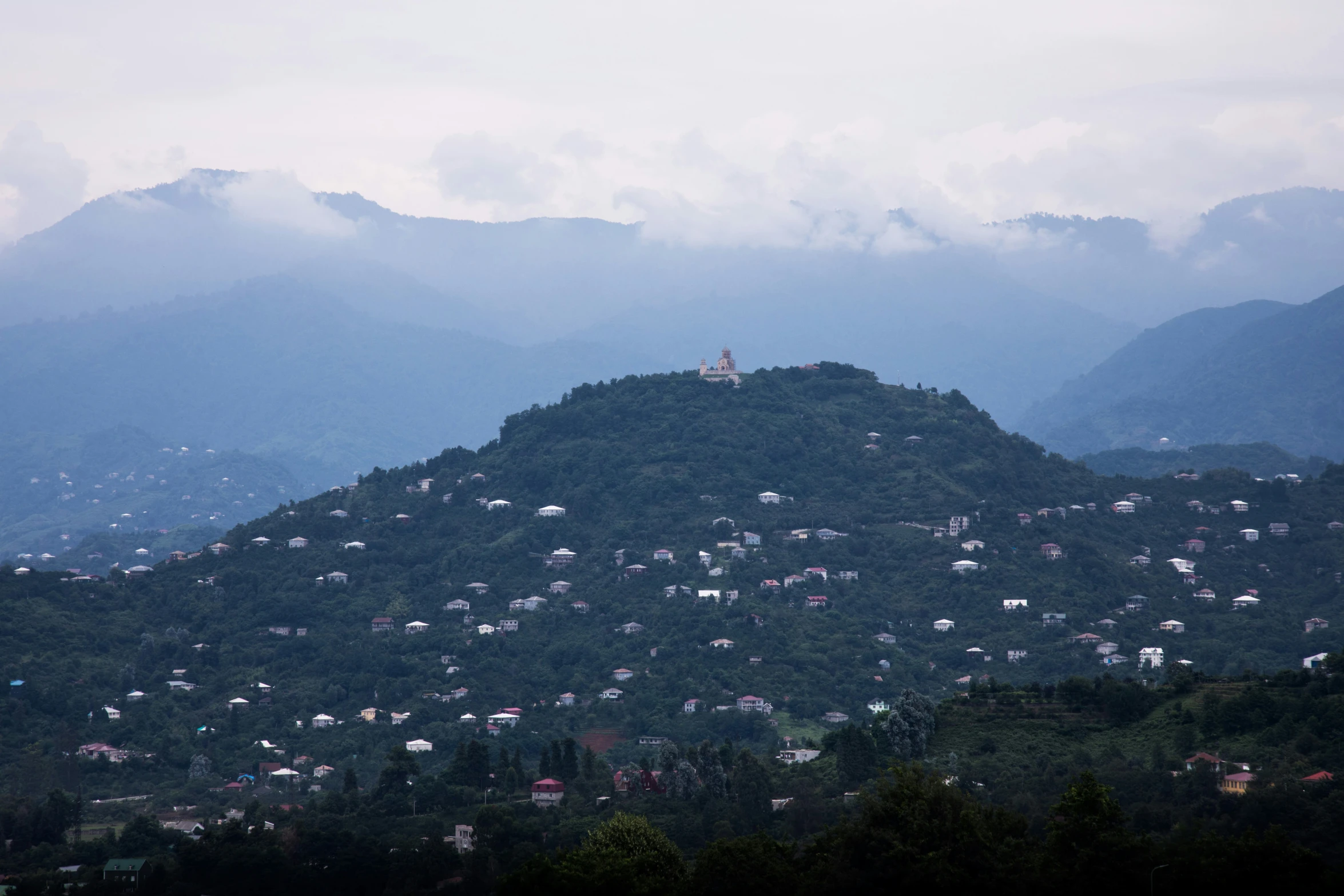 a view of a hill with houses on top of it