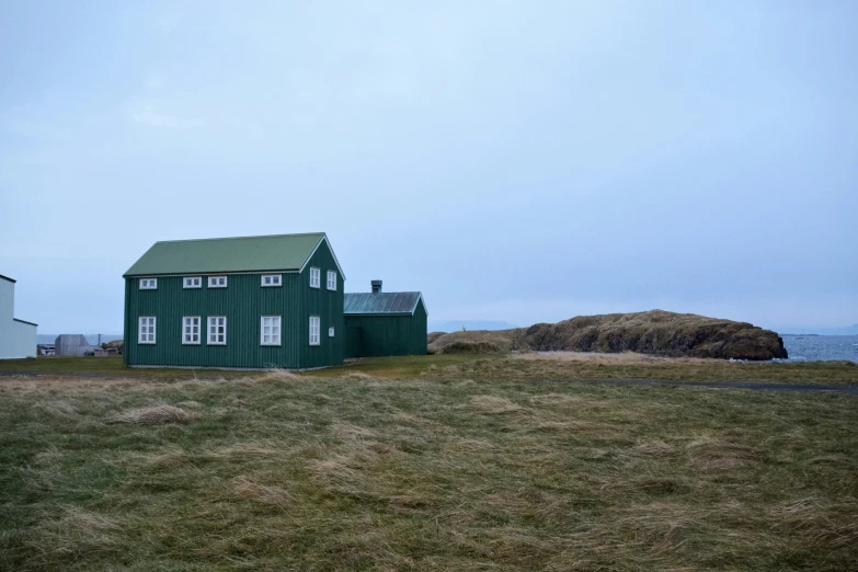 a house in the grass on an island by the water