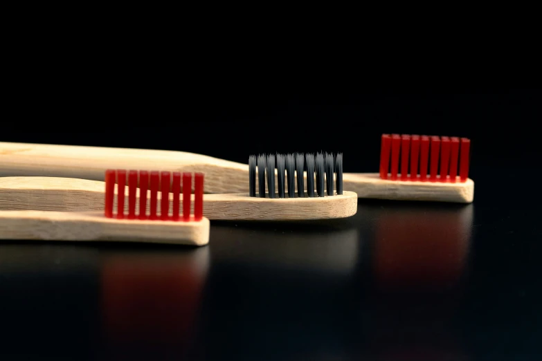three toothbrushes lined up side by side on a table
