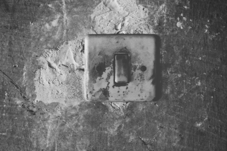 a light switch sitting in the center of a dark wall