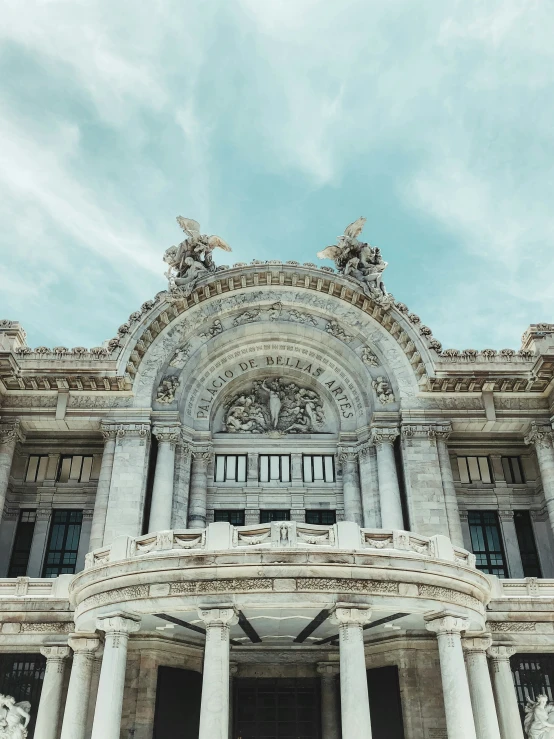 a very tall building with several statues on it