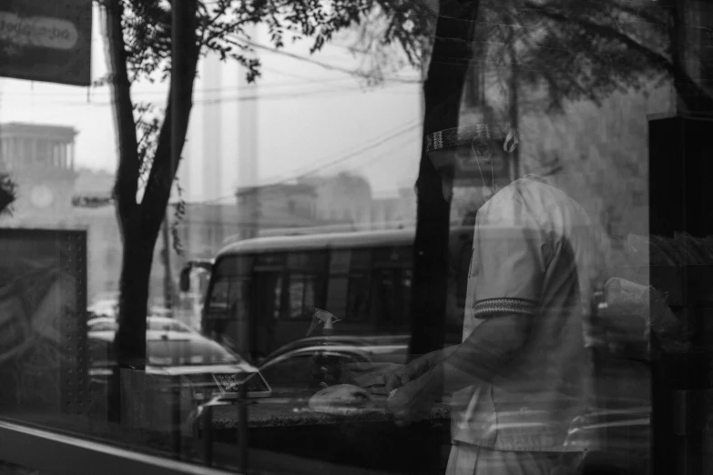 man holding a coffee cup outside of a coffee shop window