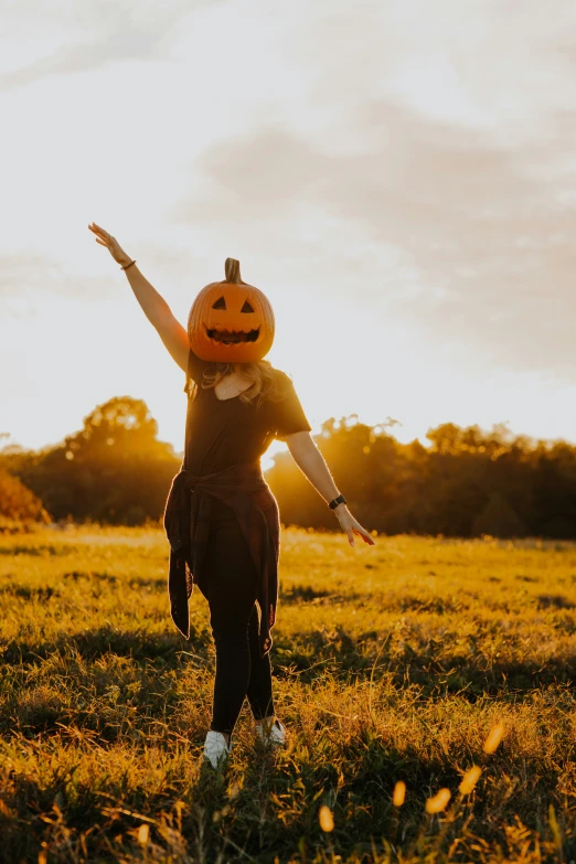 young child in halloween costume reaching into the air