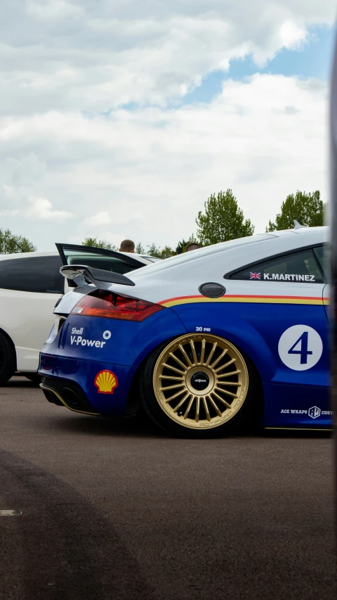 a sports car sitting beside a tour bus