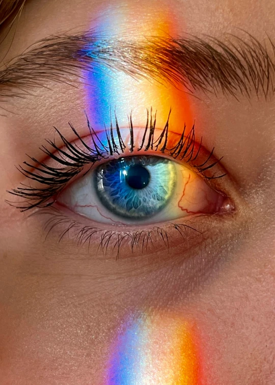 a close up of a person with colorful rainbows