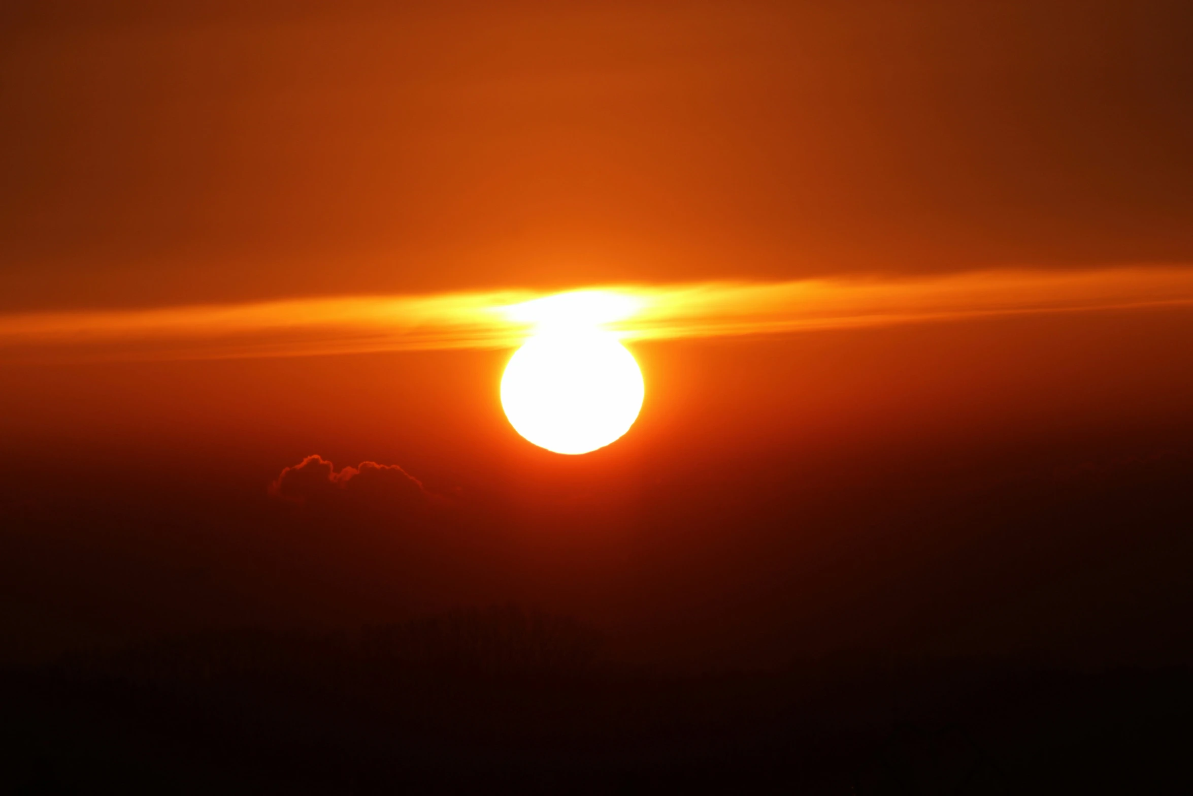 a large bright sun is seen against a gray background