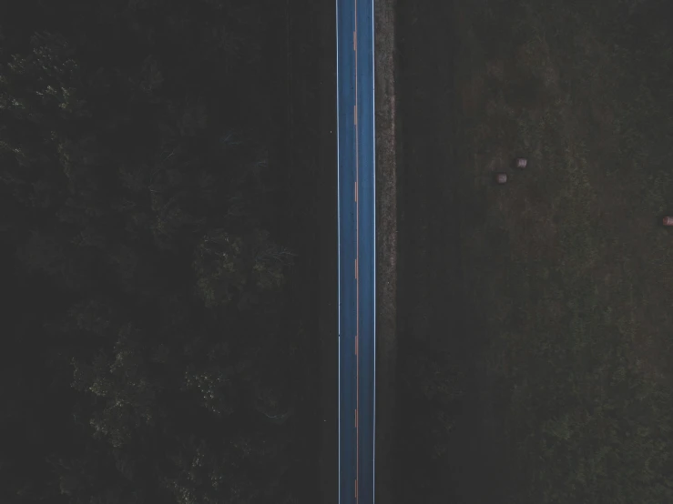 an aerial s of a long highway in the evening