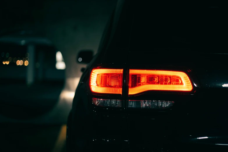 a car with its tail lights turned on at night