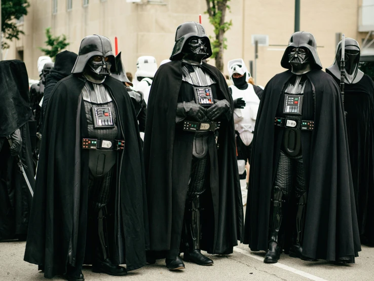 a group of people dressed as darth vader and others