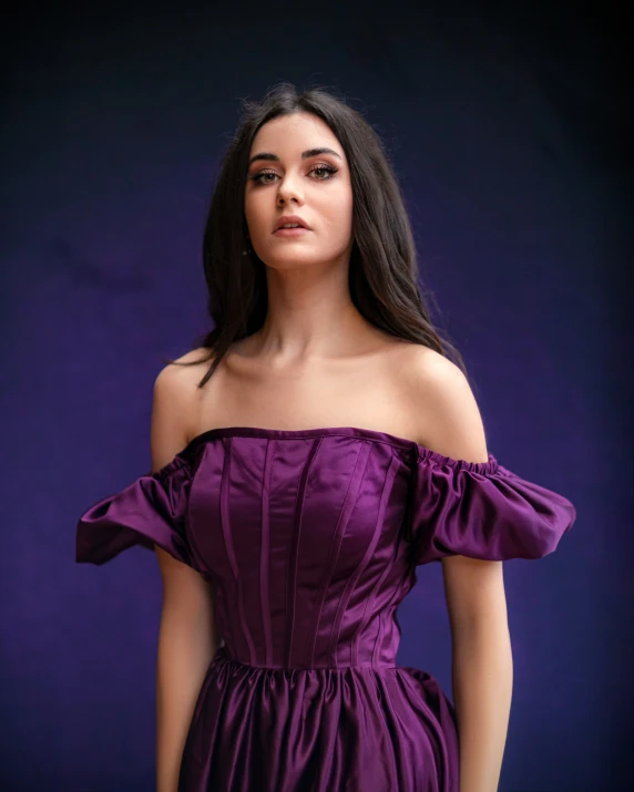 a girl in a purple dress is standing