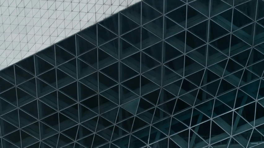 a tall building with black glass windows on the side of it