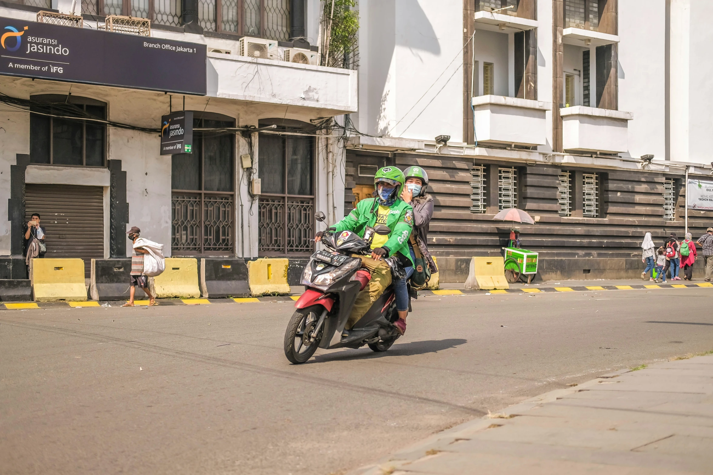 a person in green is sitting on a motorcycle