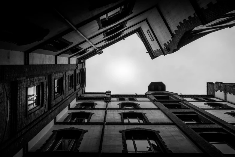 a very tall building under a cloudy sky