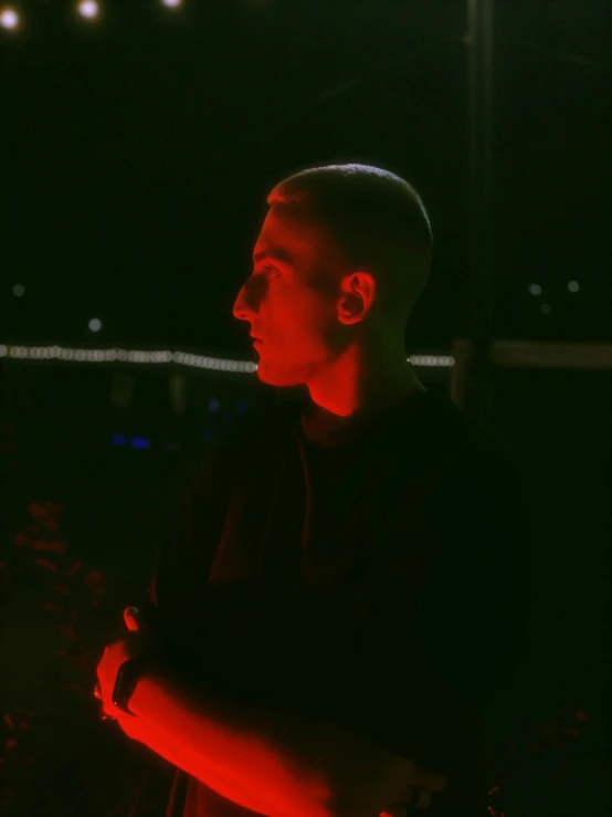 a young man is posing in front of some lights