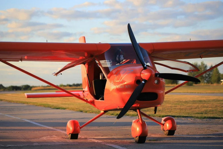 the propeller is attached to a small red plane
