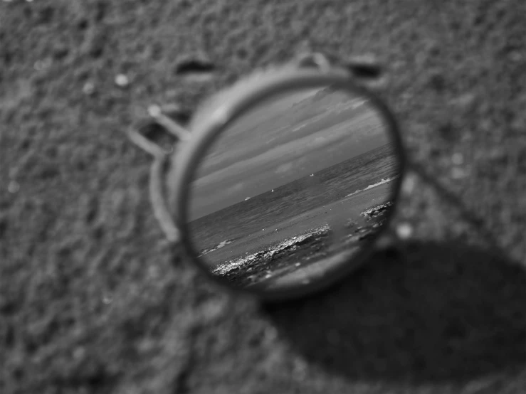 view through magnifying glass of beach landscape