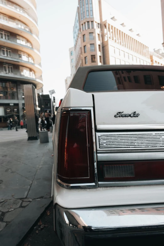 a large white car parked on the side of the road