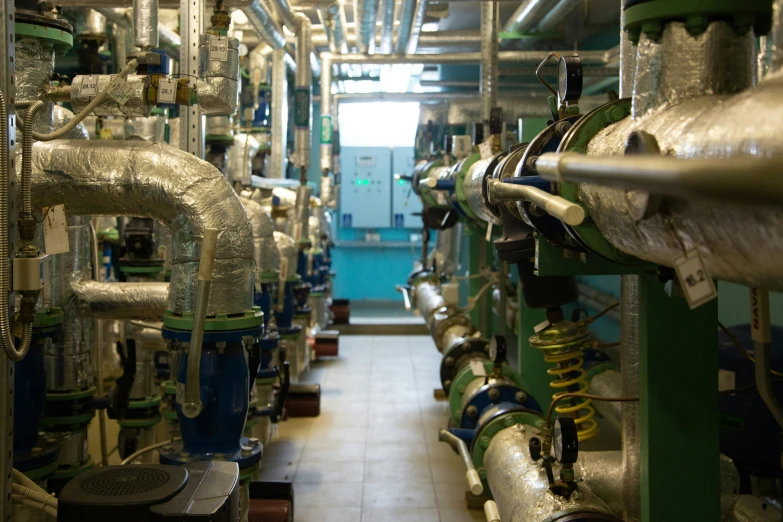 a tunnel with large pipes and various pipe valves