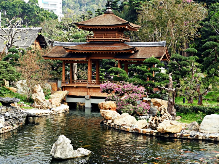 a tall pagoda sitting above a small river