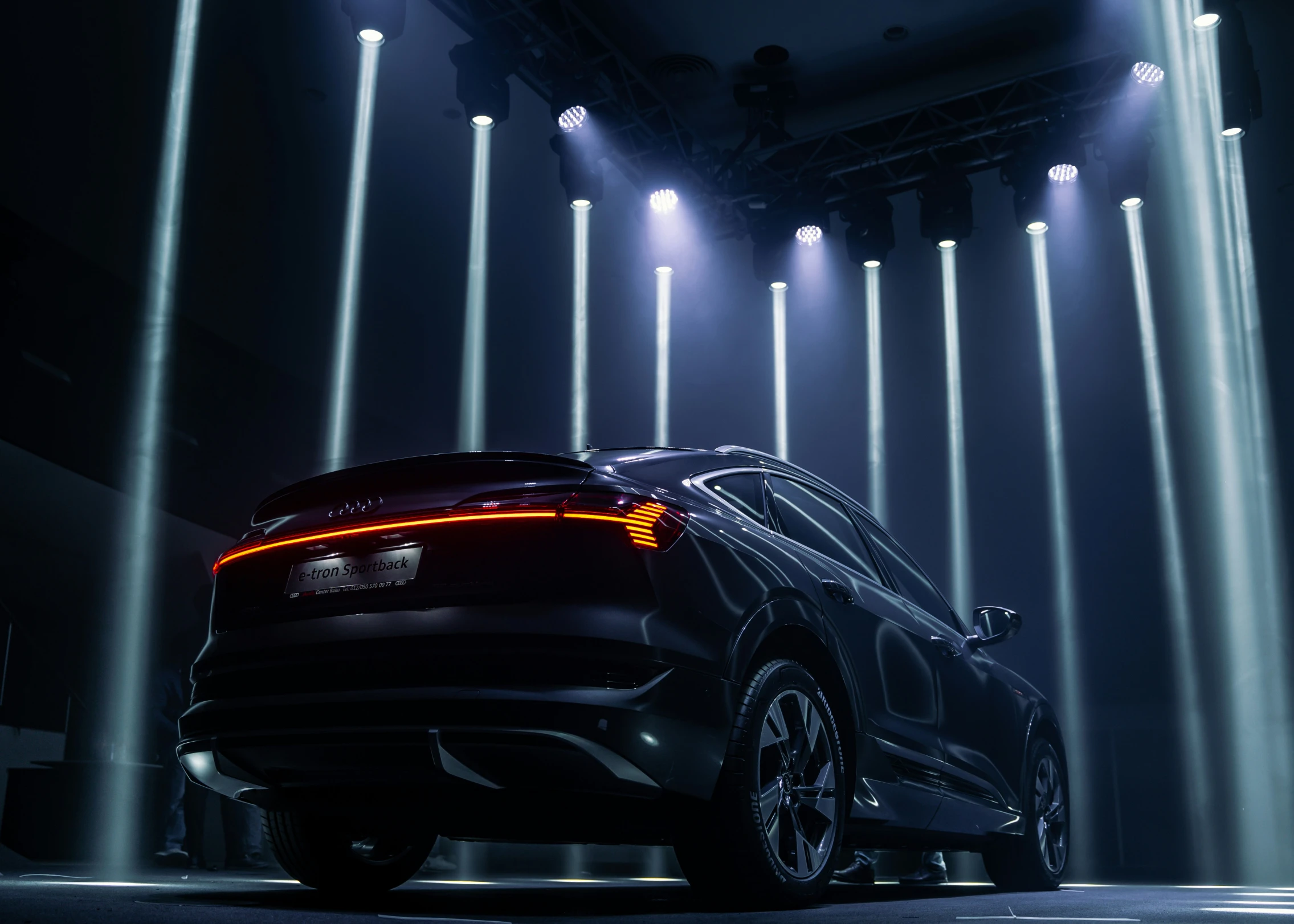 this is an automobile in a showroom with bright beams of lights