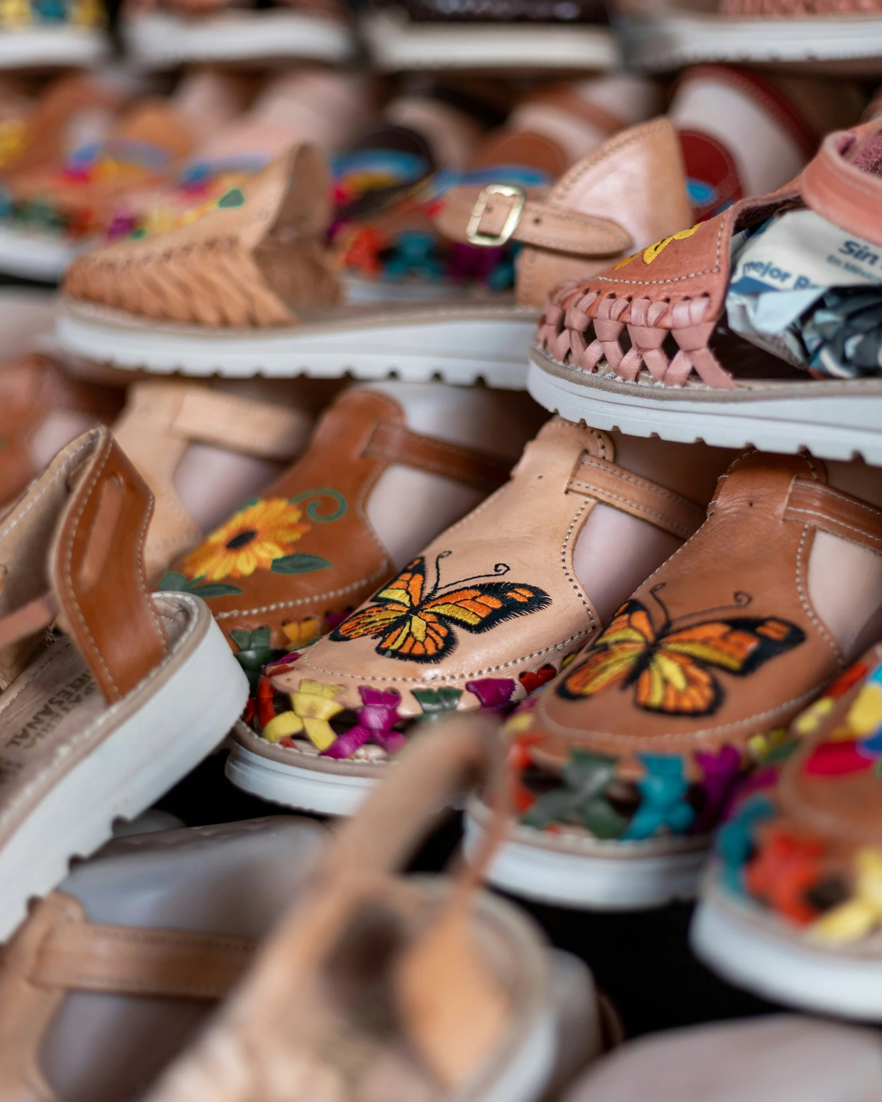 a close up of many different pairs of shoes