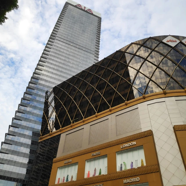 the corner of a building with a sky scr above