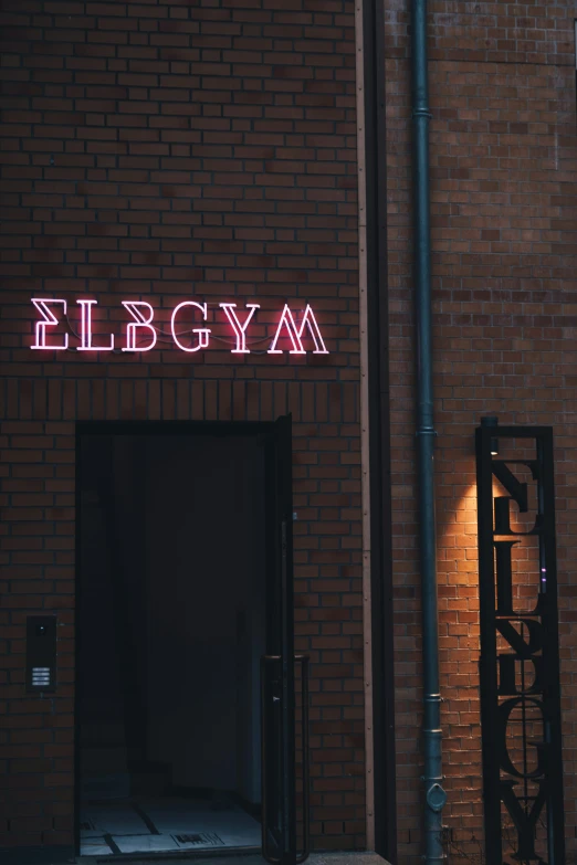 the neon light is above the door to an office building