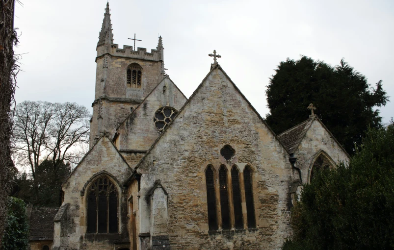 an old stone church with two crosses on the top