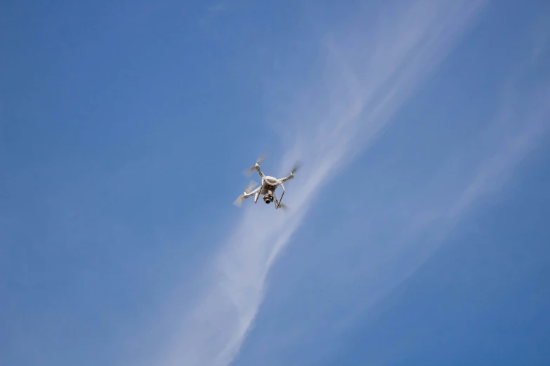 a large propeller plane flying across a blue sky