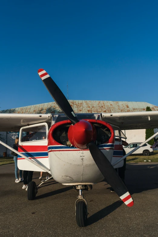 a small plane with people inside of it on the ground