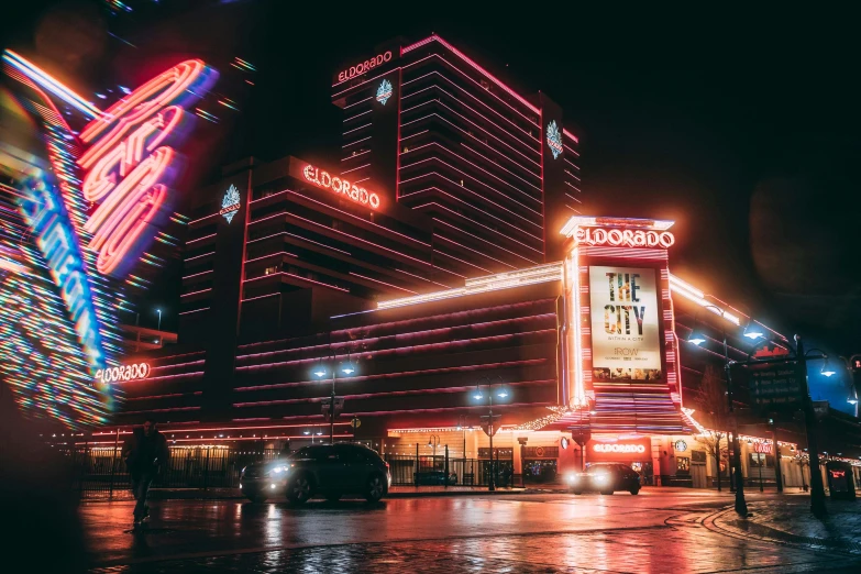 a very large building in the evening with lots of neon lights