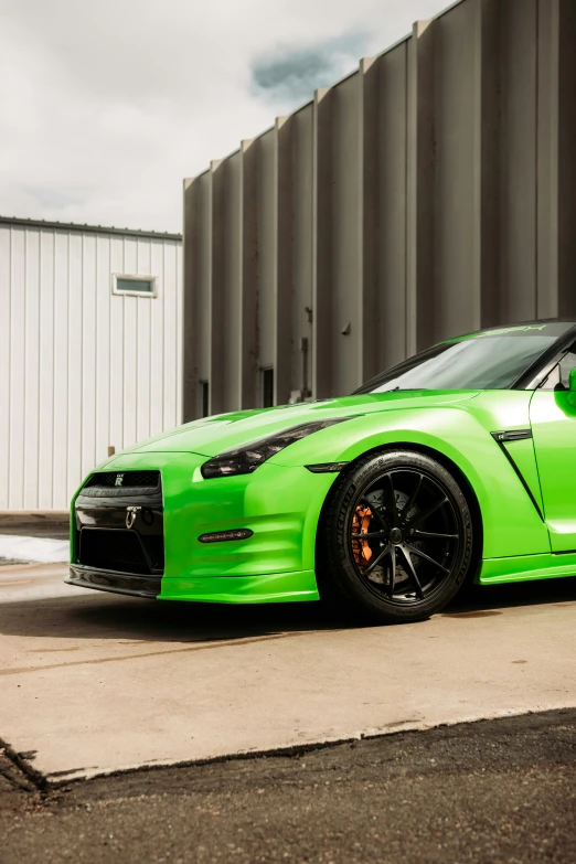 a bright green car parked in front of a building