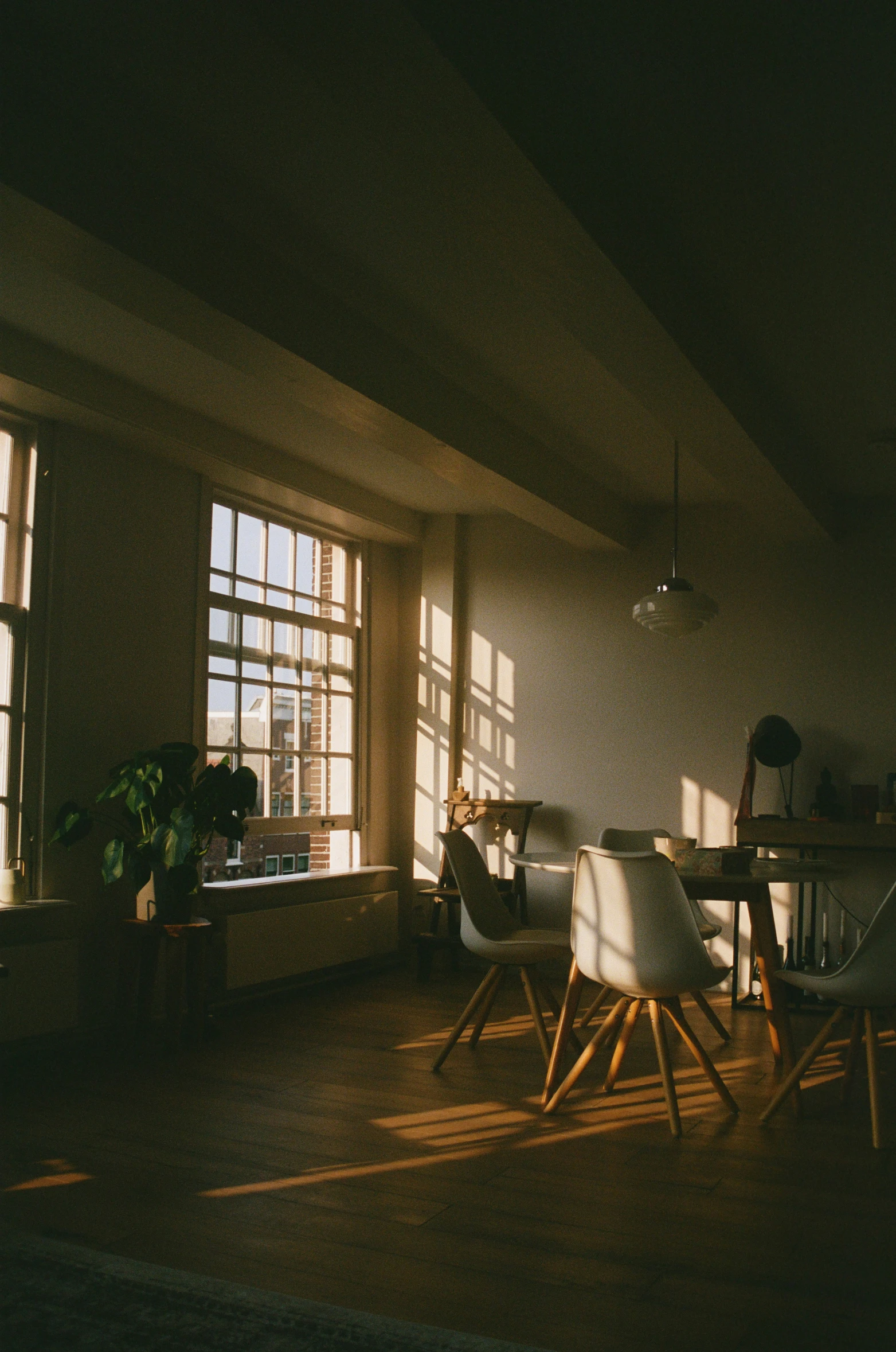 the room is dimly lit by the two large windows