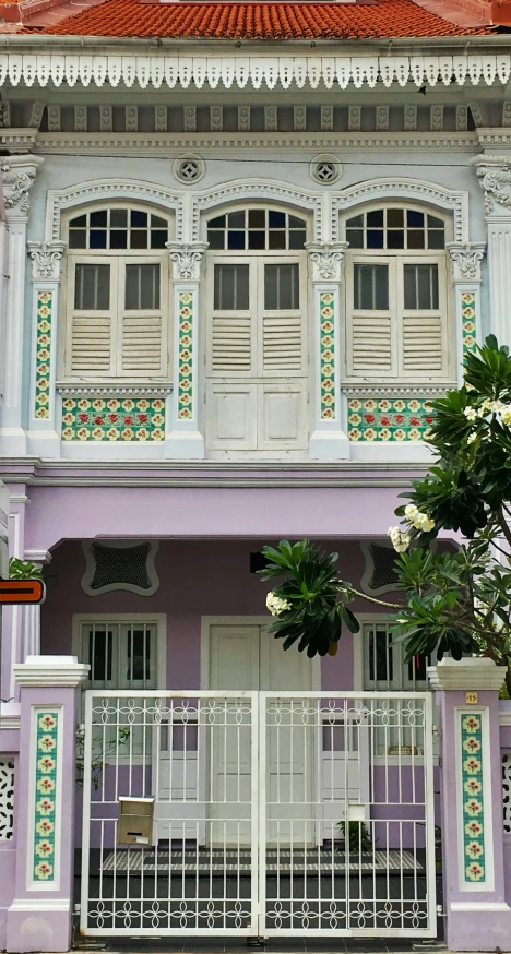 two large white fences in front of a purple building