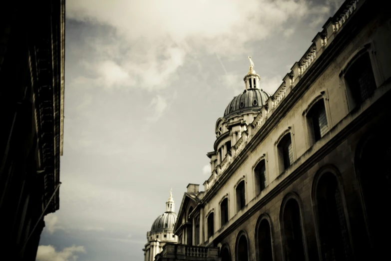 looking up at a domed building in an otherwise older city