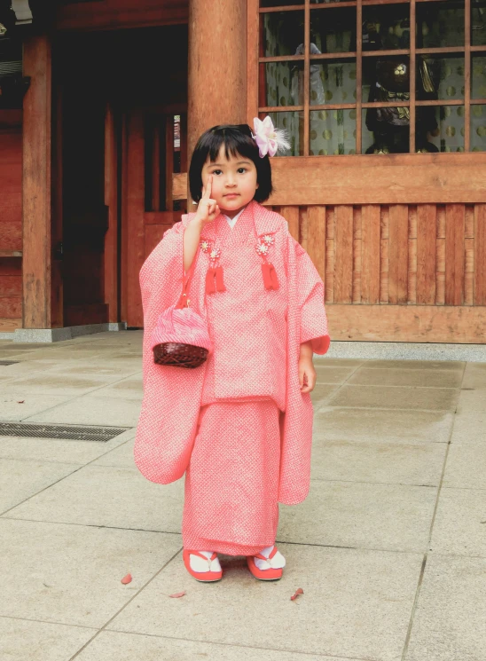 small asian girl in red dress posing for the camera