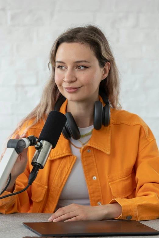 a woman with headphones sitting in front of a microphone