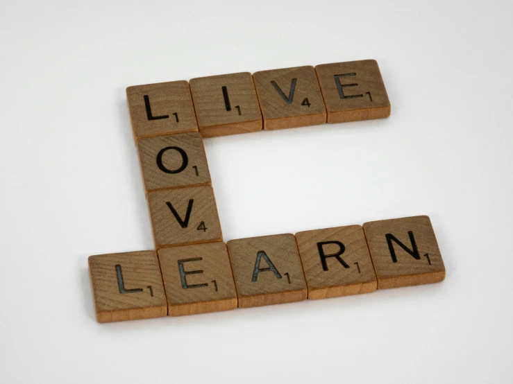 the words live, learn, and love are spelled in scrabble