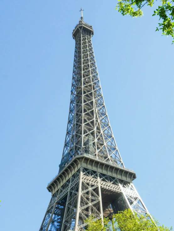 a tall tower sitting above some trees in the day time