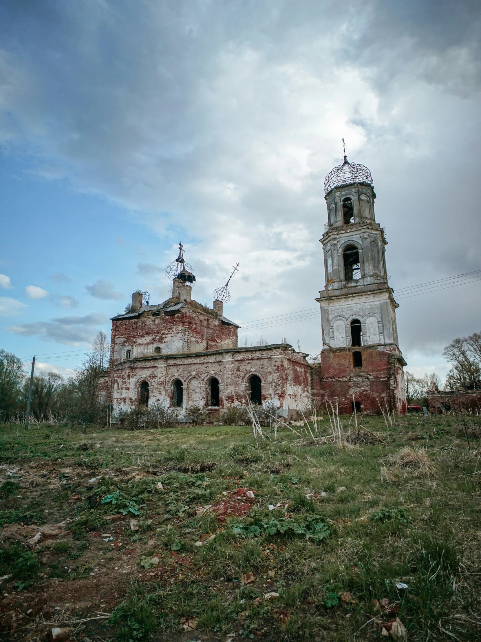a dilapidated building with two towers on the side