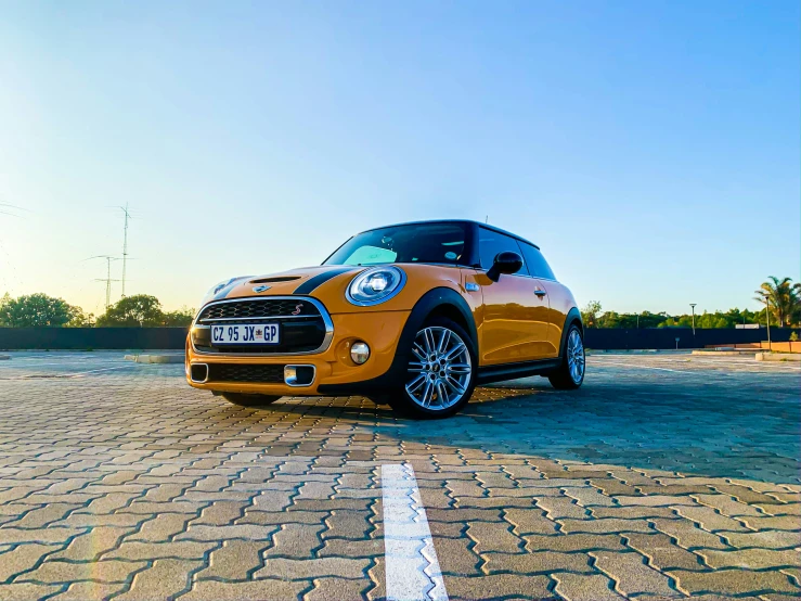 the mini car is parked in the parking lot