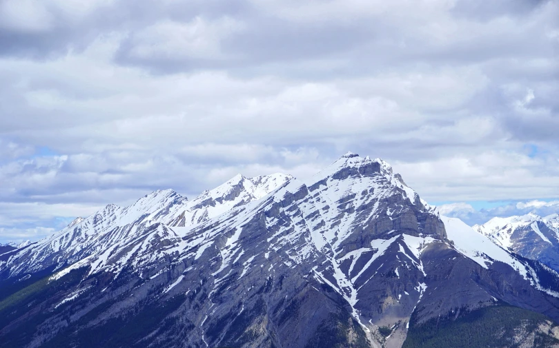 the snowy mountain peaks of the mountainside are in the distance