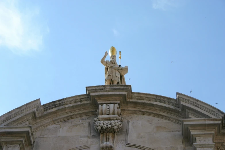 the front view of a building with decorative angel decorations