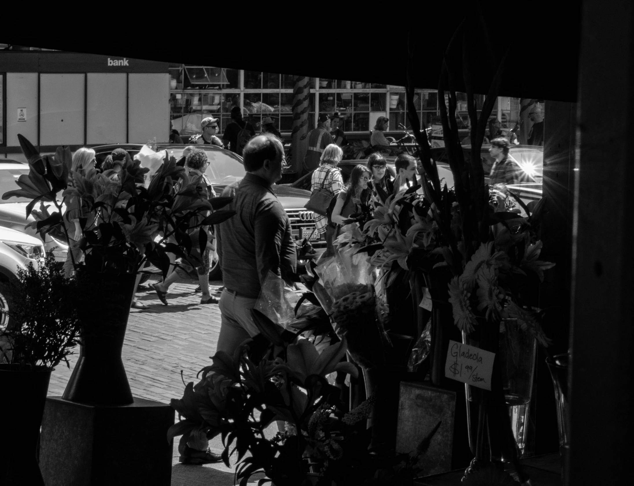 black and white po of woman walking down street