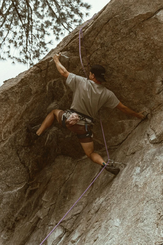 a person on the side of a mountain with climbing gear