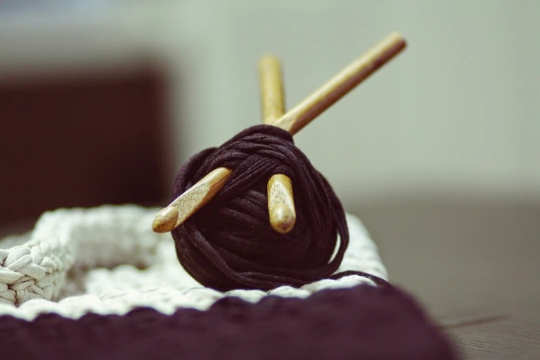 yarn and wooden skeins laid on top of a table