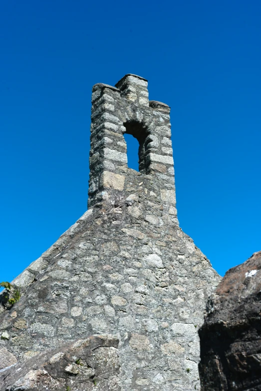 an old tower with a small opening in it