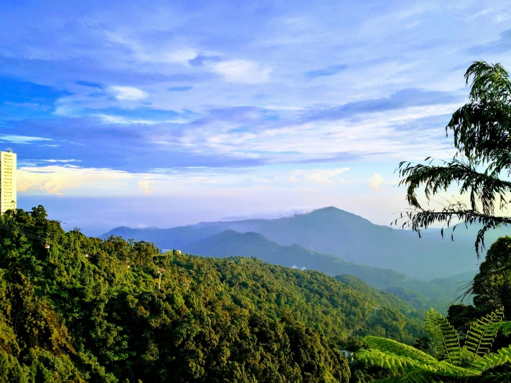 the sky is blue over some green hills