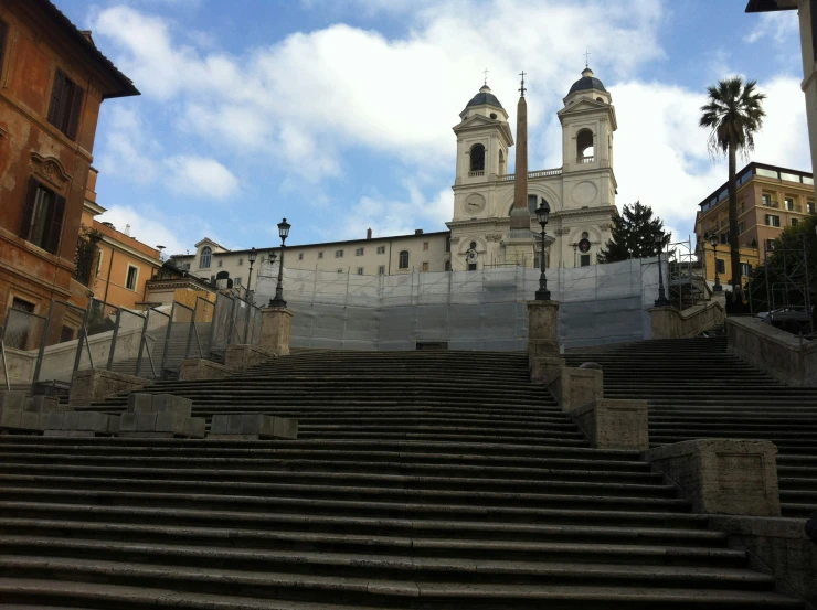 a very large church tower towering over some stone stairs