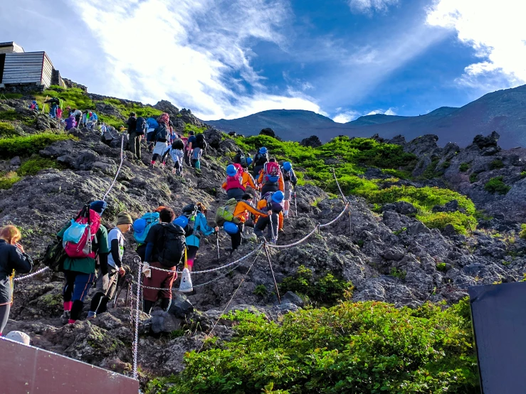 there are many hikers climbing up this mountain